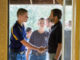 boy shaking Chief's hand as he enters chuckwagon