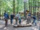 boys cutting wood with bow saws