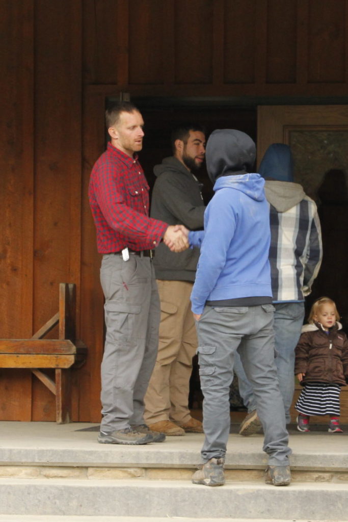 supervisors shaking boys hands as they enter chuckwagon